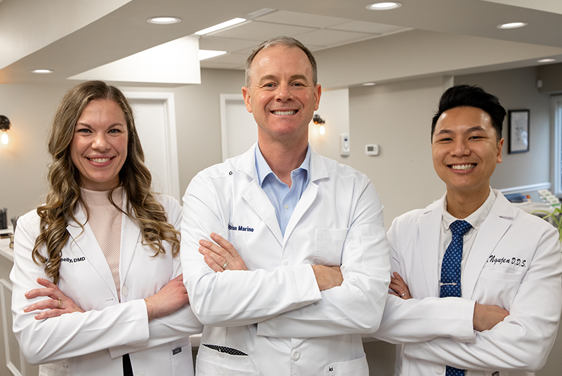 all three doctors standing in the lobby with their arms crossed